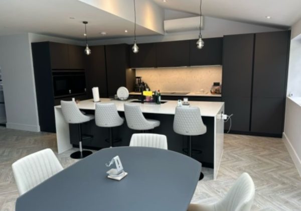 Pendent lighting shown in a modern black and white kitchen