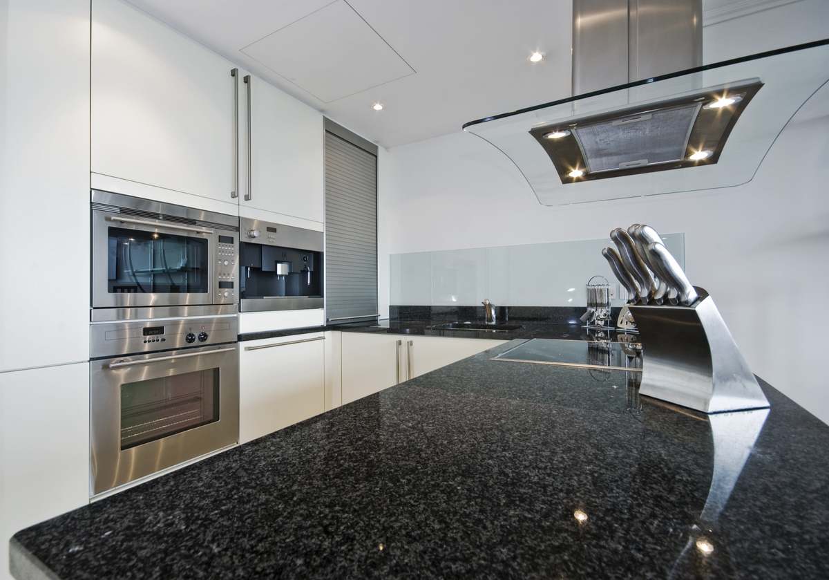 Granite kitchen worktop in a white kitchen